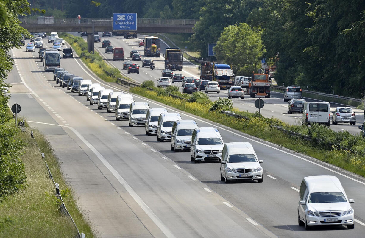 A convoy of hearses drives on the highway in Duisburg, Germany, on Wednesday taking home 16 school children who died in the Germanwings plane crash in March.