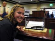 Ilah Hickman poses Monday with a young Idaho giant salamander at the Idaho state Capitol in Boise, Idaho.