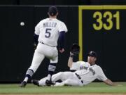 Seattle Mariners left fielder Seth Smith can't get to the ball, while shortstop Brad Miller (5) watches on a single by San Francisco Giants' Angel Pagan during the eighth inning Thursday, June 18, 2015, in Seattle.