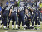 Seattle Seahawks quarterback Russell Wilson (3) huddles up the offense against the New York Giants in the second half Sunday, Nov. 9, 2014, in Seattle.