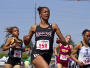 Union sophomore Dai'lyn Merriweather crosses the finish line to win the 4A girls 200 meters at the state track and field championships Saturday in Tacoma (Patrick Hagerty/For The Columbian)