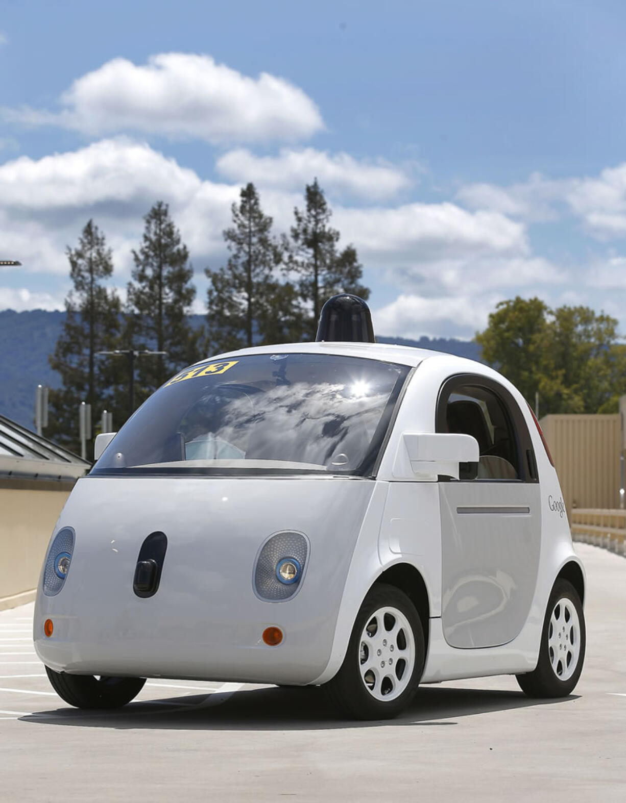 Google's new self-driving prototype car drives around a parking lot May 13 during a demonstration at the Google campus in Mountain View, Calif.