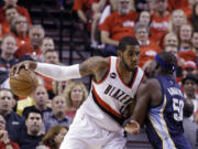 Portland Trail Blazers forward LaMarcus Aldridge, left, works the ball in against Memphis Grizzlies forward Zach Randolph during the first half of Game 4 in Portland on Monday, April 27, 2015.