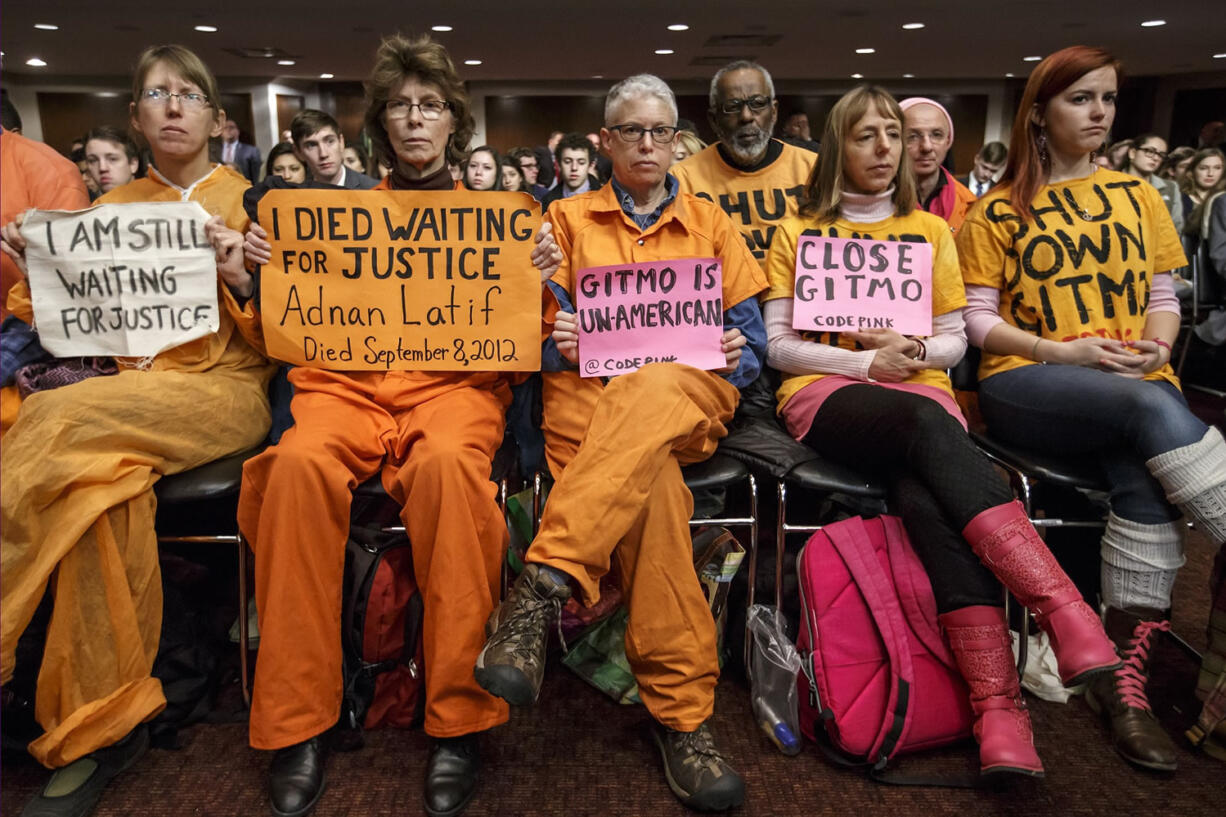 Activists from the antiwar group CodePink, including co-founder Medea Benjamin, second from right, hold silent protest at the Senate Armed Services Committee during a hearing on the detention center in Guantanamo, Cuba, on Thursday on Capitol Hill in Washington.