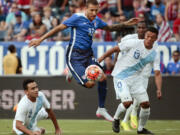 United States' Fabian Johnson midfielder (23) moves the ball between Guatemala defenders Carlos Castrillo (13) and Ruben Morales (2) during the first half of an international friendly soccer match Friday, July 3, 2015, in Nashville, Tenn.