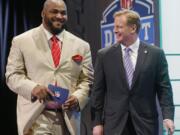 Walter Jones, left, walks with NFL Commissioner Roger Goodell after Jones announced a Seattle Seahawks'  pick at the 2014 NFL Draft in New York.