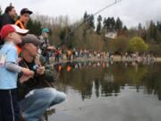 Cayden Crabtree, 5, fishes next to his father, Chase, along with hundreds of other children in the 10 a.m.