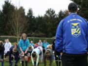 Salmon Creek Soccer Club coach Paul Madden looks on as U-11 tryouts stretch before taking the fields for drills and exhibition play to see who will make this spring's select and premier teams.