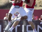 Eastern Washington quarterback Vernon Adams, left, celebrates his touchdown with wide receiver Cooper Kupp against Idaho State during the first quarter Saturday, Oct. 4, 2014, in Cheney.