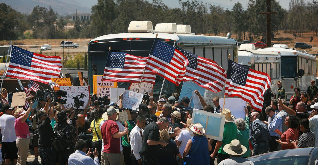 Protesters turn back three buses carrying 140 immigrants Tuesday as they attempt to enter the Murrieta U.S.