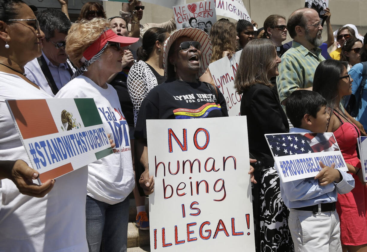 Associated Press
Lucy Francis, of Lynn, Mass., center, holds a placard and chants slogans during a rally Tuesday on the steps of City Hall in Lynn, Mass., held to protest what organizers describe as the scapegoating of immigrants for problems in the city.