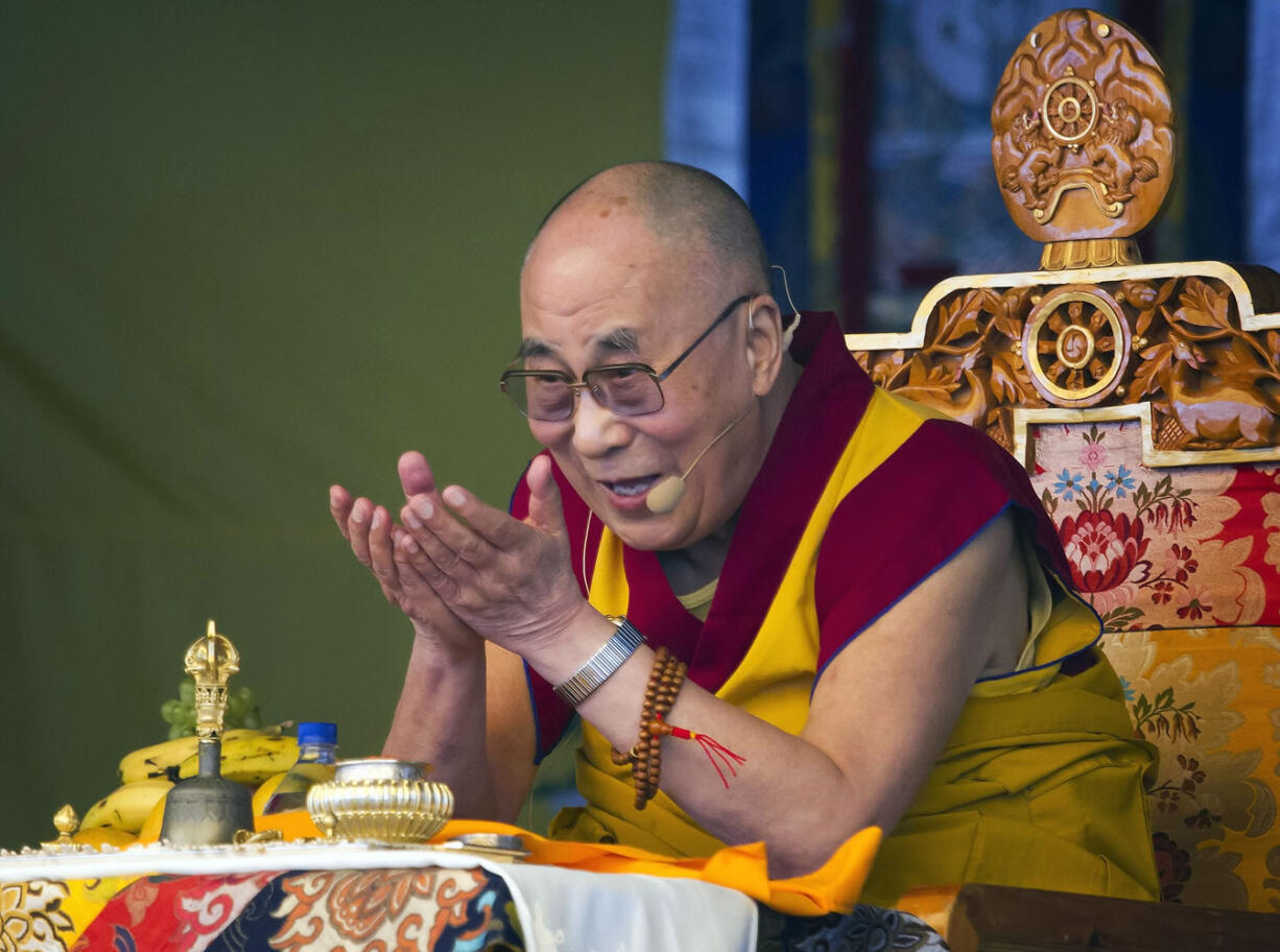 Tibetan spiritual leader the Dalai Lama gestures as he talks during a special ritual ceremony at the Tibetan Children's Village School in Dharmsala, India.