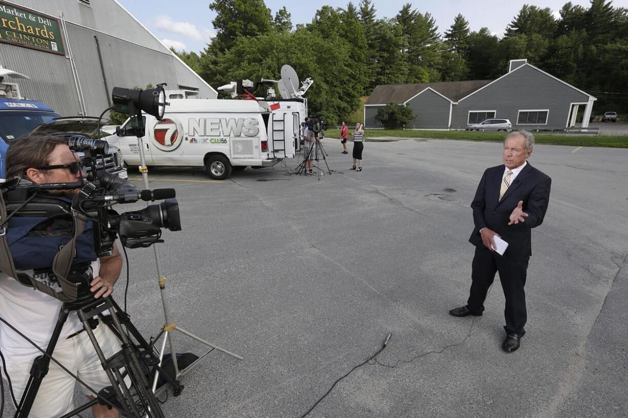 Television news crews gather Wednesday near a business in Bolton, Mass. The business belonging to relatives of Keith Broomfield, an American fighting with Kurdish forces against the Islamic State group in Syria has been killed in battle, authorities said Wednesday, likely the first U.S.