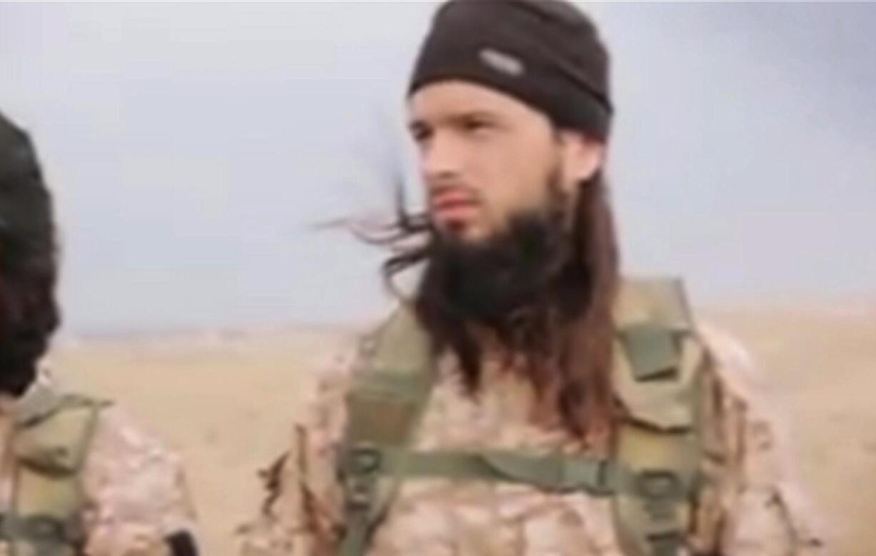 This still image taken from an undated video published on the Internet by the Islamic State group militants and made available Sunday shows a militant that the French government say is Frenchman Maxime Hauchard.