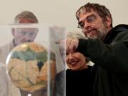 Associated Press files
Brother Guy Consolmagno, a Jesuit astronomer at the Vatican's Observatory, right, shows to visitors the Globe of planet Mars from the collection of the Specola Vaticana during an exhibition celebrating the 400th anniversary of demonstration of Galileo's telescope April 15 on the Gianicolo hill, at Rome's American Academy in Rome.