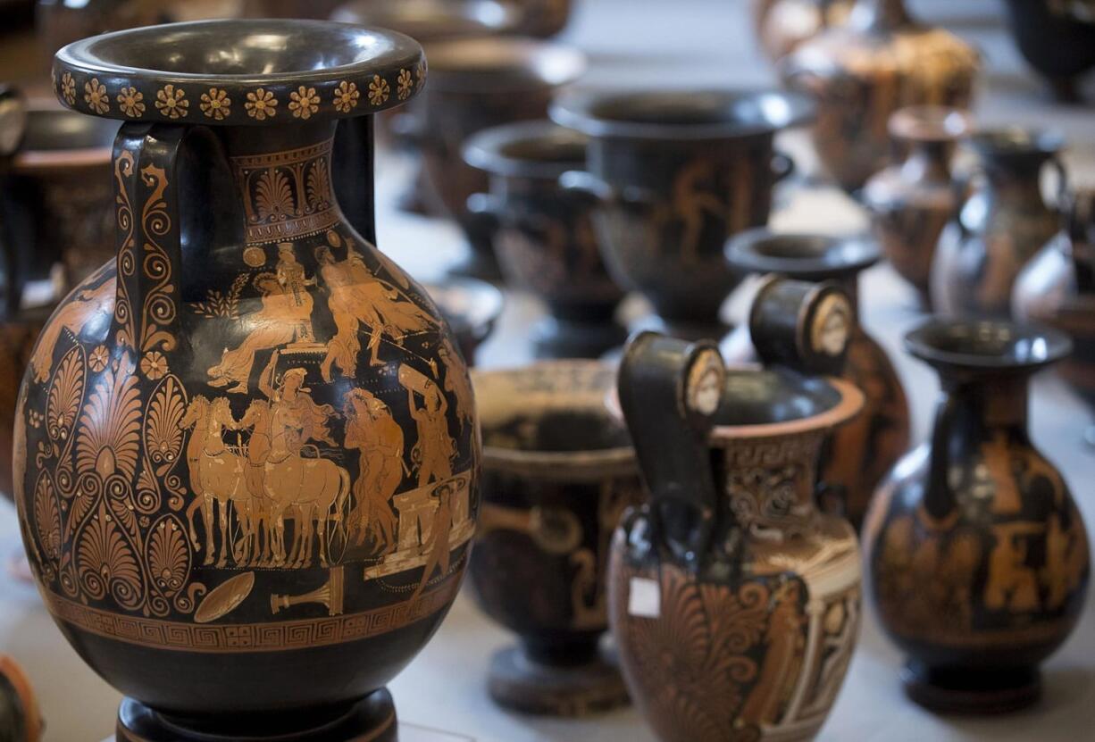 Antiquities recovered by Italian Carabinieri, military police, are displayed at Terme di Diocleziano museum during a press conference in Rome, Wednesday, Jan. 21, 2015. Italian authorities have unveiled what they said was a record haul of rare antiquities illegally looted from Italy and discovered during raids on Swiss warehouses belonging to an accused Sicilian art dealer. The carabinieri police's art squad estimated the value of the 5,361 vases, kraters, bronze statues and frescoes at some 50 million euros. The works, from the 8th century B.C. to the 3rd century A.D., were laid out Wednesday at the National Roman Museum and may go on public display. Carabineri Gen. Mariano Mossa said it was &quot;by a long shot the biggest recovery in history in terms of the quantity and quality of archaeological treasures.&quot; They were found during an investigation into Basel-based art dealer Gianfranco Becchina, accused by prosecutors of being part of a huge trafficking network.