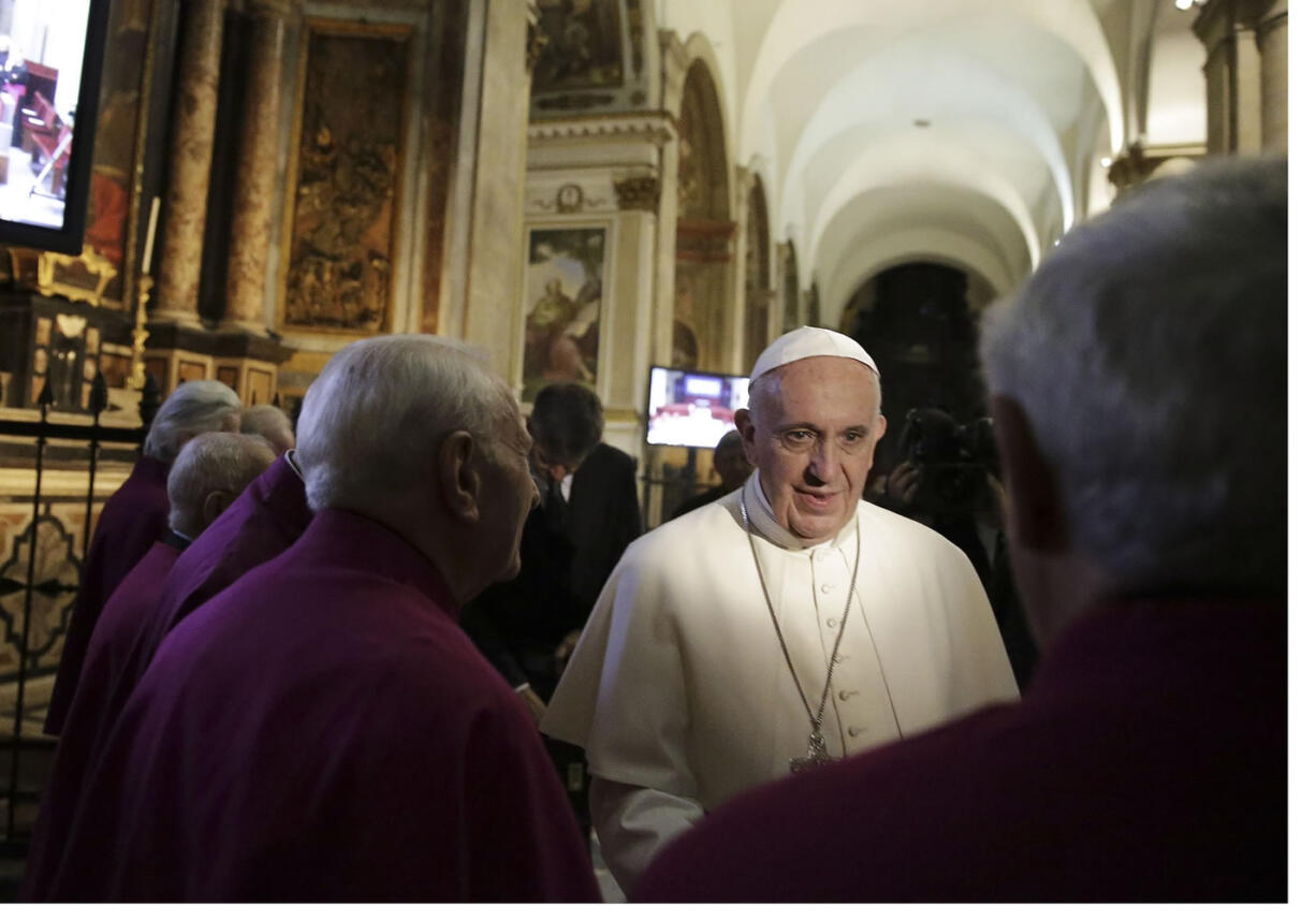 Pope Francis greets bishops Sunday as he leaves after praying in front of the Holy Shroud, revered by some as the burial cloth of Jesus, at the Cathedral of Turin, Italy,.