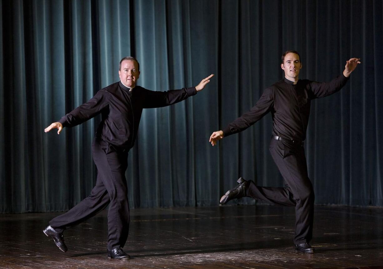 Father David Rider, left, and father John Gibson dance before an interview with the Associated press at the Pontifical North American College in Rome on Monday.