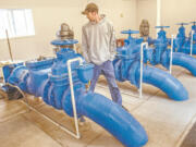 Sam Gibbons, manager of the Kalama Falls Hatchery, walks through the pump room where a problem led to the death of 200,000 fish last week.