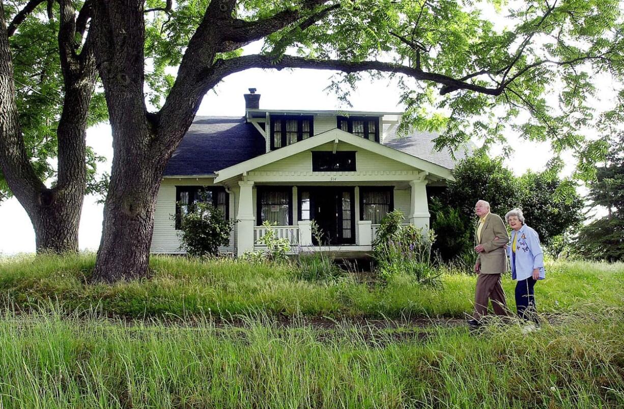 Ed and Virginialee &quot;Dollie&quot; Lynch walk together in July 2002 past an old farm house on Franklin Street, adjacent to Franklin Elementary School. Parks fans, the Lynches gave the 10 acres the house sits on for a Vancouver park. The Lynches donated the 10 acres the house sits on to the Community Foundation of Southwest Washington, which made $1 million for charity by selling the land to Vancouver to be developed into a Vancouver park.