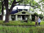 Ed and Virginialee &quot;Dollie&quot; Lynch walk together in July 2002 past an old farm house on Franklin Street, adjacent to Franklin Elementary School. Parks fans, the Lynches gave the 10 acres the house sits on for a Vancouver park. The Lynches donated the 10 acres the house sits on to the Community Foundation of Southwest Washington, which made $1 million for charity by selling the land to Vancouver to be developed into a Vancouver park.