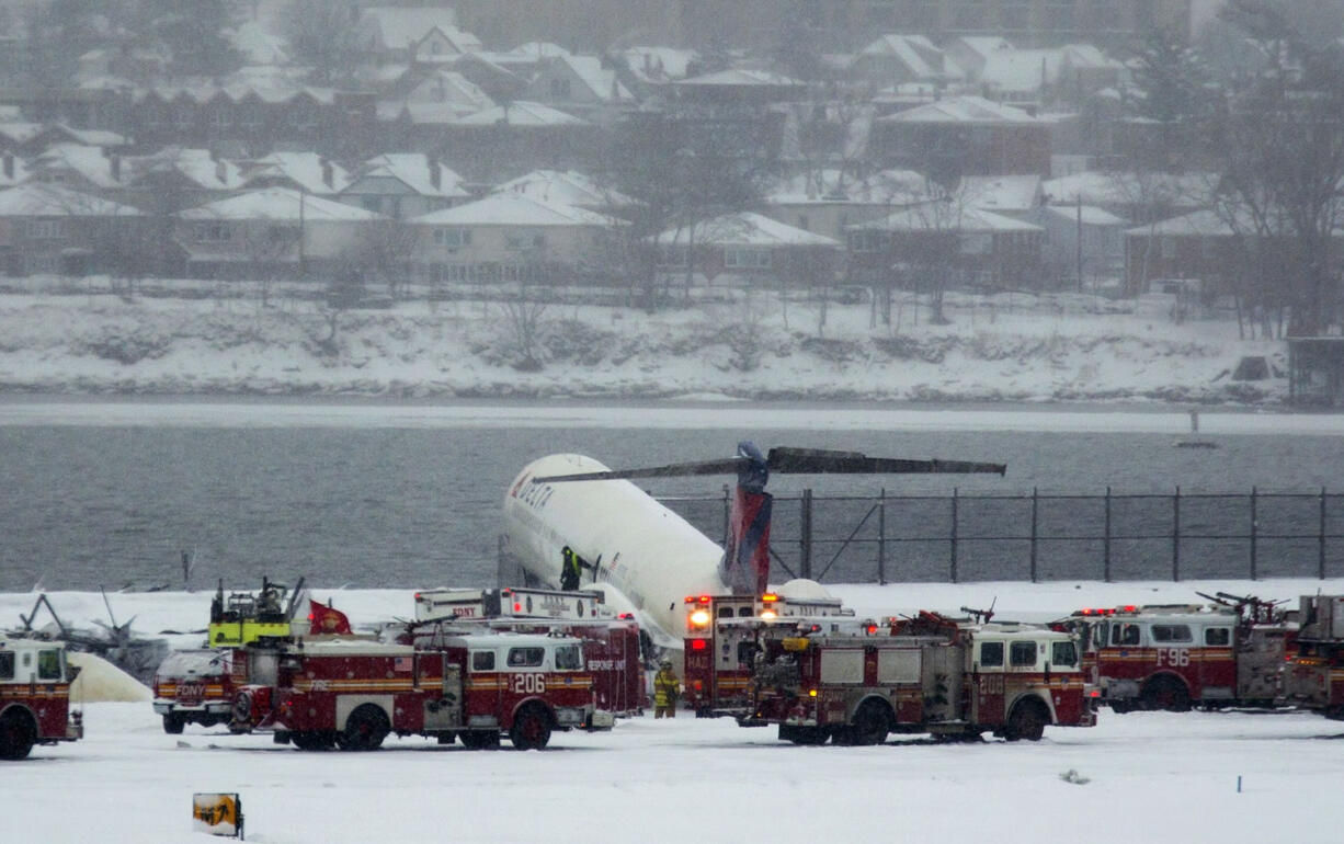 A Delta plane rests on a berm near the water at LaGuardia Airport in New York, Thursday, March, 2015. Delta Flight 1086, carrying 125 passengers and five crew members, veered off the runway at around 11:10 a.m., authorities said. Six people suffered non-life-threatening injuries, said Joe Pentangelo, a spokesman for the Port Authority of New York and New Jersey, which runs the airport.