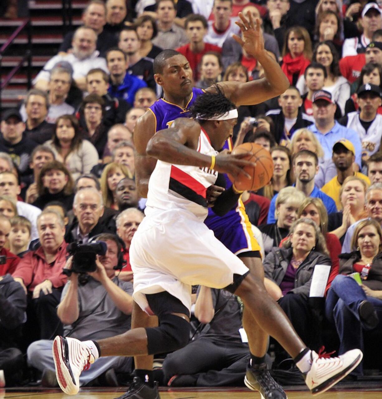 Portland's Gerald Wallace drives on Lakers forward Metta World Peace during the first half Thursday.