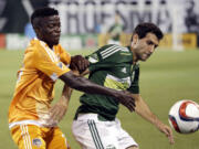 Portland Timbers midfielder Diego Valeri, right, battles Houston Dynamo midfielder Rasheed Olabiyi for possession during the first half of Friday's game at Providence Park.