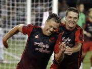 Portland Timbers defender Jack Jewsbury, left, celebrates his goal during stoppage time with teammate Will Johnson against the San Jose Earthquakes in Portland on Sunday, July 5, 2015. The Timbers won 1-0.