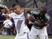 Los Angeles Galaxy forward Jose Villarreal, left, and Portland Timbers midfielder Diego Chara battle for the ball during the first half of an MLS soccer game in Portland, Ore., Sunday, March 15, 2015.