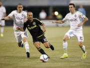 Columbus Crew forward Federico Higuain (10) battles for the ball against Seattle Sounders midfielders Osvaldo Alonso (6) and and Marco Pappa (10) during the first half of an MLS soccer game in Columbus, Ohio, on Saturday, May 9, 2015.