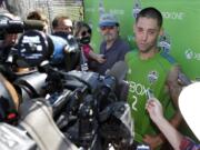 Seattle Sounders' Clint Dempsey talks to reporters following a training session, Friday, July 11, 2014, in Tukwila, Wash. It was Dempsey's first day back training with the Sounders after his time with the U.S. Men's National Team at the World Cup in Brazil. (AP Photo/Ted S.