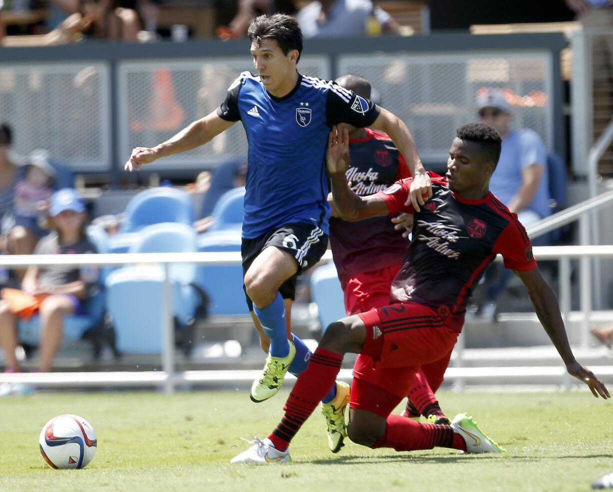 San Jose Earthquakes midfielder Shea Salinas, left, and Portland Timbers defender Alvas Powell, right, race for the ball during the first half Sunday, Aug.