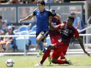 San Jose Earthquakes midfielder Shea Salinas, left, and Portland Timbers defender Alvas Powell, right, race for the ball during the first half Sunday, Aug.