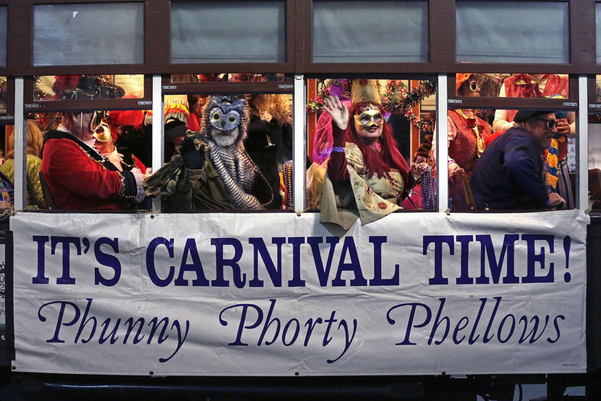 Associated Press files
Members of the Phunny Phorty Phellows celebrate aboard a streetcar on Jan. 6 in New Orleans. King's Day is a tradition marking the 12th night after Christmas and the official start of the Mardi season.