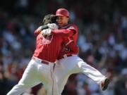 Los Angeles Angels' Grant Green, left, celebrates his ninth-inning walk-off single with Efren Navarro as the Angels beat the Seattle Mariners on Sunday, 6-5. (AP Photo/Jae C.