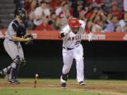 Los Angeles Angels' Efren Navarro hits a walk-off single during the 16th inning against the Seattle Mariners in the wee hours Saturday, in Anaheim, Calif. The Angels won 3-2. (AP Photo/Jae C.