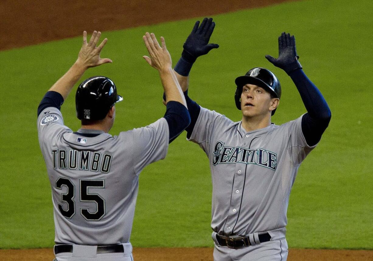 Seattle Mariners' Logan Morrison celebrates with teammate Mark Trumbo in the third inning after hitting his second home run against the Houston Astros on Saturday, June 13, 2015.