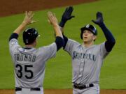 Seattle Mariners' Logan Morrison celebrates with teammate Mark Trumbo in the third inning after hitting his second home run against the Houston Astros on Saturday, June 13, 2015.