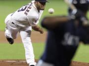 Houston Astros' Lance McCullers, left, delivers a pitch to Seattle Mariners' Austin Jackson in the first inning Sunday, June 14, 2015, in Houston.