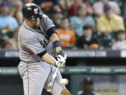 Seattle Mariners' John Buck hits an RBI single against the Houston Astros in the sixth inning Wednesday in Houston.