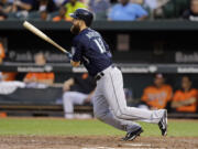 Seattle Mariners' Dustin Ackley watches his solo home run in the third inning against the Baltimore Orioles, Saturday, Aug. 2, 2014, in Baltimore.