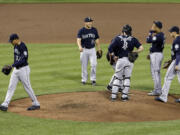 Seattle Mariners starting pitcher Taijuan Walker, left, walks off the field after being relieved in the fourth inning of a baseball game against the Baltimore Orioles, Tuesday, May 19, 2015, in Baltimore. Baltimore won 9-4.