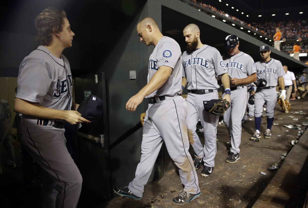 Seattle Mariners third baseman Kyle Seager, center, walks out of the dugout with teammates after Friday's 2-1 loss to Baltimore.