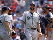 Seattle Mariners relief pitcher Joe Beimel leaves the mound after giving up three straight home runs to the Texas Rangers during the seventh inning of a baseball game Wednesday, Aug. 19, 2015, in Arlington, Texas. The Rangers defeated the Mariners 7-2.