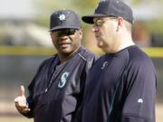 Seattle Mariners manager Lloyd McClendon, left, talks to bench coach Trent Jewett during spring training practice Saturday, Feb. 21, 2015, in Peoria, Ariz.