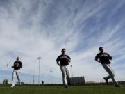 Seattle pitcher Roenis Elias, left, runs with teammates during practice Saturday.