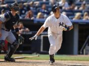 Seattle Mariners catcher Mike Zunino, left, and New York Yankees Mark Teixeira watch Texeira's eighth-inning, tie-breaking, go-ahead, solo home run at Yankee Stadium in New York, Sunday, July 19, 2015.