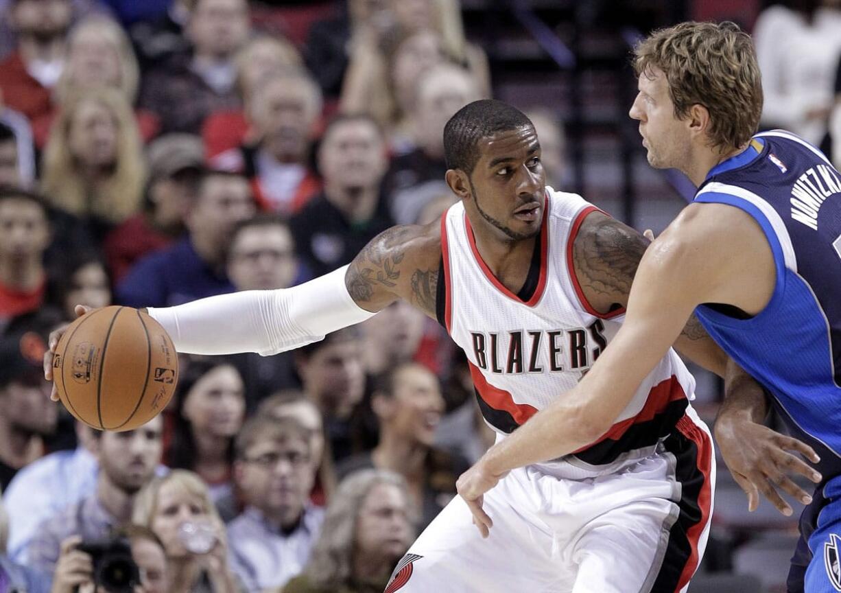 Don Ryan/Associated Press
Portland's LaMarcus Aldridge, left, works the ball in against Dallas' Dirk Nowitzki on Thursday.