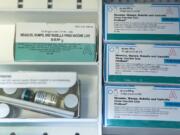 Boxes of the measles, mumps and rubella virus vaccine and measles, mumps, rubella and varicella vaccine are shown inside a freezer at a doctor's office in Northridge, Calif.